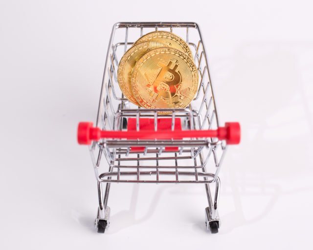 Buying Bitcoin. Conceptual Shot. Gold Coins In A Grocery Cart. B