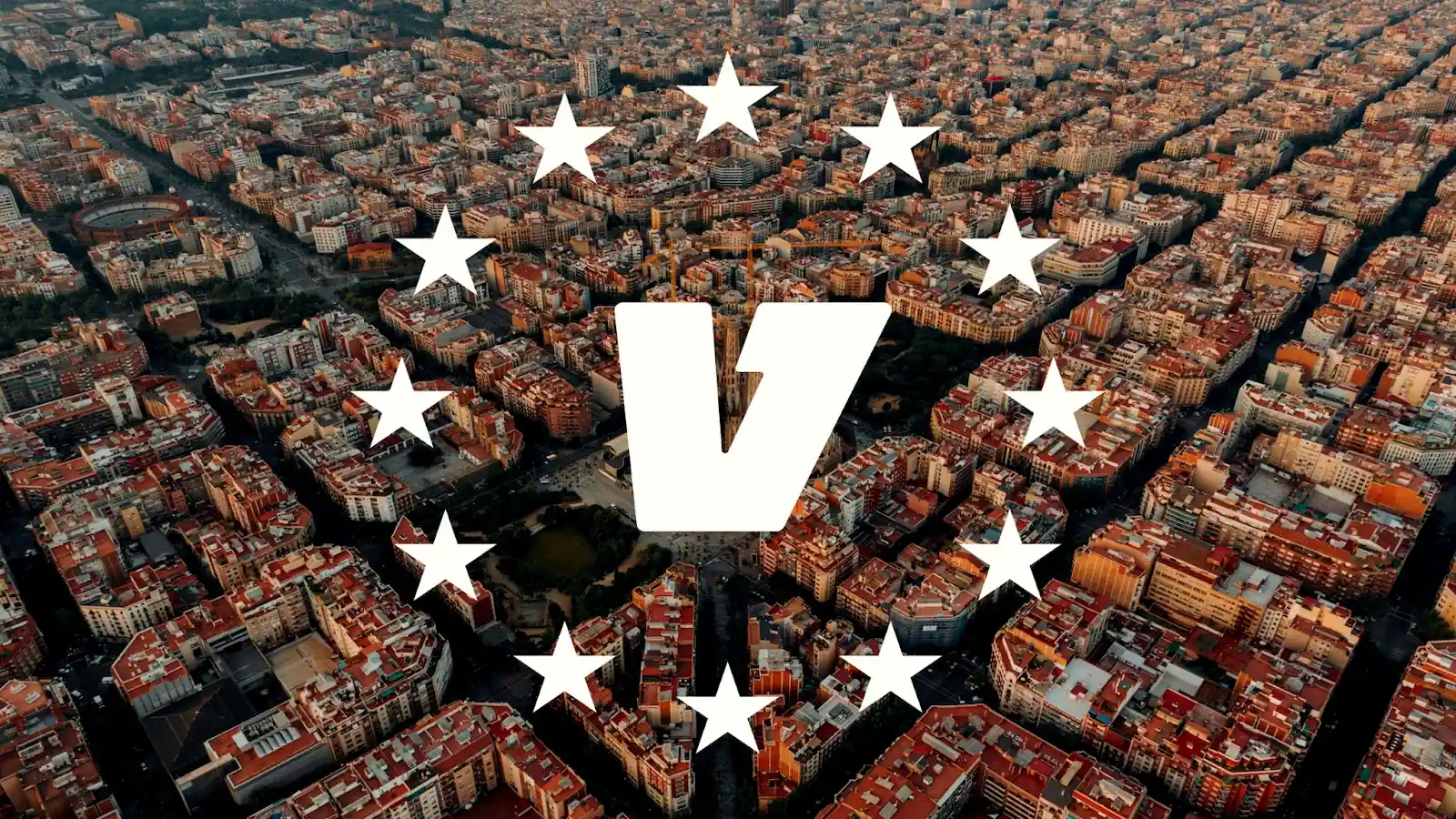 Aerial photograph of Barcelona's Eixample district with its distinctive grid pattern, overlaid with a white "V" logo surrounded by stars in a circle, resembling EU-style branding.